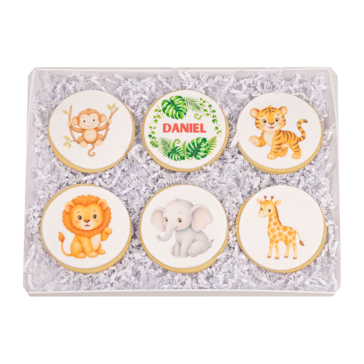 Open personalized jungle animal cookie gift box with six sugar cookies featuring a monkey, tiger, lion, elephant, giraffe, and name